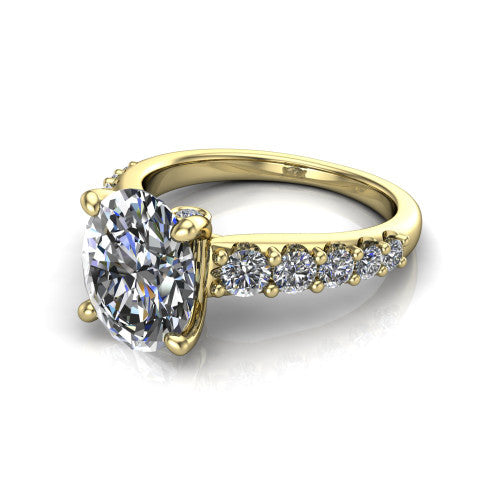 Nina oval solitaire engagement ring in 14K Yellow Gold, three-quarter perspective showing the brilliant oval center diamond on a pave-accent shank with a hidden under-halo beneath the center stone