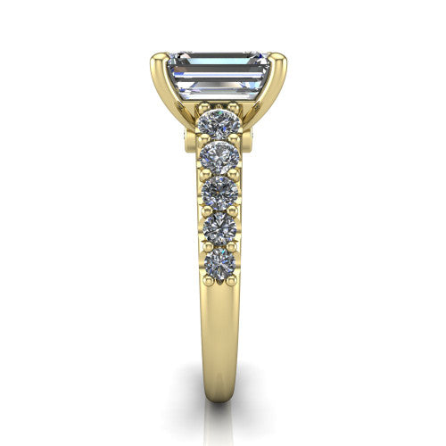 Nina emerald solitaire engagement ring in 14K Yellow Gold, side profile showing the hidden under-halo beneath the center stone and pave diamonds along the shoulders
