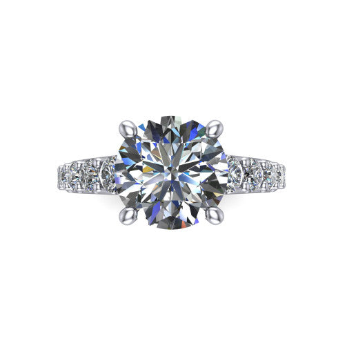 Nina round solitaire engagement ring in 18K White Gold, top-down view showing the brilliant round center diamond held by four prongs above the pave shoulder accents