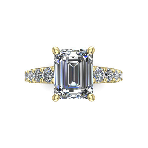 Nina emerald solitaire engagement ring in 14K Yellow Gold, top-down view showing the step-cut emerald center diamond held by four prongs above the pave shoulder accents