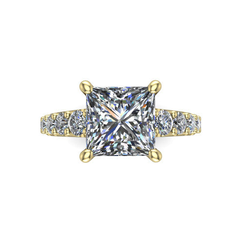 Nina princess solitaire engagement ring in 18K Yellow Gold, top-down view showing the brilliant princess-cut center diamond held by four prongs above the pave shoulder accents