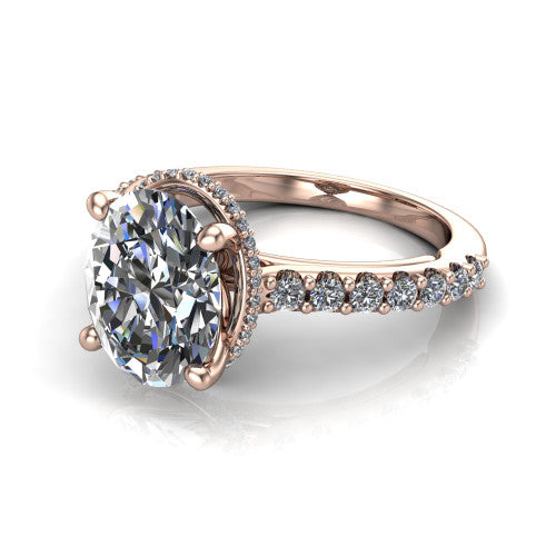 Nadia oval hidden halo engagement ring in 18K Rose Gold, three-quarter perspective showing the brilliant oval center diamond with a hidden pave halo beneath the center stone on a pave eternity band