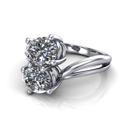 Lexi oval three stone engagement ring in Platinum, three-quarter perspective showing two brilliant oval diamonds set diagonally on a bypass split shank with plain bands