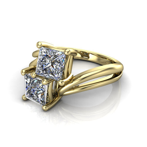 Lexi princess three stone engagement ring in 18K Yellow Gold, three-quarter perspective showing two brilliant princess-cut diamonds set diagonally on a bypass split shank with plain bands