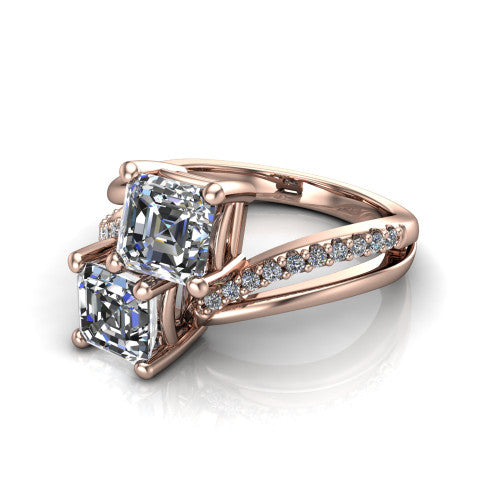 Julieta square emerald three stone engagement ring in 14K Rose Gold, three-quarter perspective showing two step-cut square emerald diamonds set diagonally on a bypass split shank with pave diamonds