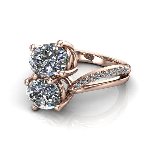 Julieta oval three stone engagement ring in 18K Rose Gold, three-quarter perspective showing two brilliant oval diamonds set diagonally on a bypass split shank with pave diamonds