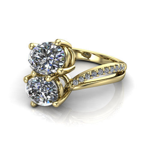 Julieta oval three stone engagement ring in 14K Yellow Gold, three-quarter perspective showing two brilliant oval diamonds set diagonally on a bypass split shank with pave diamonds
