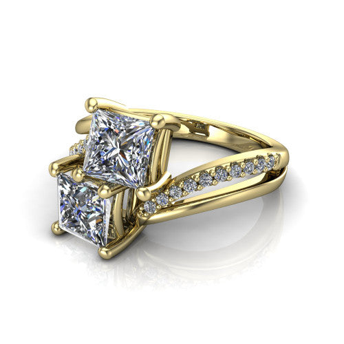 Julieta princess three stone engagement ring in 14K Yellow Gold, three-quarter perspective showing two brilliant princess-cut diamonds set diagonally on a bypass split shank with pave diamonds