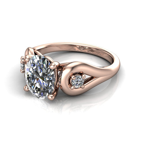 Imani oval three stone engagement ring in 18K Rose Gold, three-quarter perspective showing the brilliant oval center diamond flanked by two round side diamonds in square frames on bypass loop shoulders