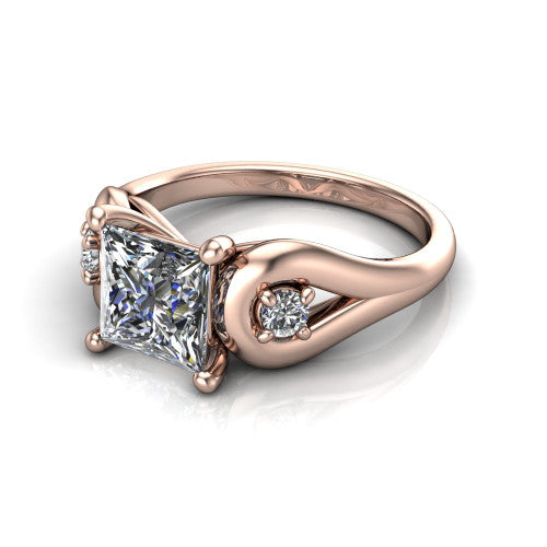 Imani princess three stone engagement ring in 14K Rose Gold, three-quarter perspective showing the brilliant princess-cut center diamond flanked by two round side diamonds in square frames on bypass loop shoulders