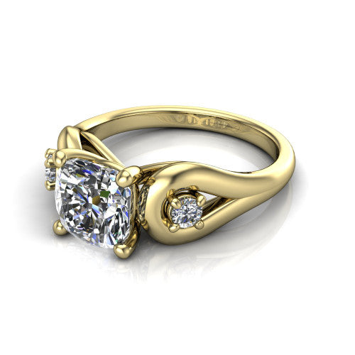 Imani cushion three stone engagement ring in 18K Yellow Gold, three-quarter perspective showing the brilliant cushion-cut center diamond flanked by two round side diamonds in square frames on bypass loop shoulders