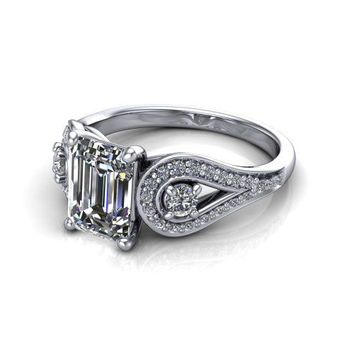 Jennifer emerald three stone engagement ring in Platinum, three-quarter perspective showing the step-cut emerald center diamond flanked by two round side diamonds in pave teardrop frames on a pave split shank