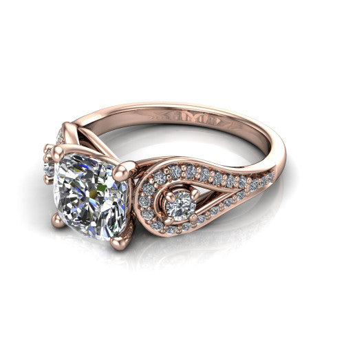 Jennifer cushion three stone engagement ring in 18K Rose Gold, three-quarter perspective showing the brilliant cushion-cut center diamond flanked by two round side diamonds in pave teardrop frames on a pave split shank