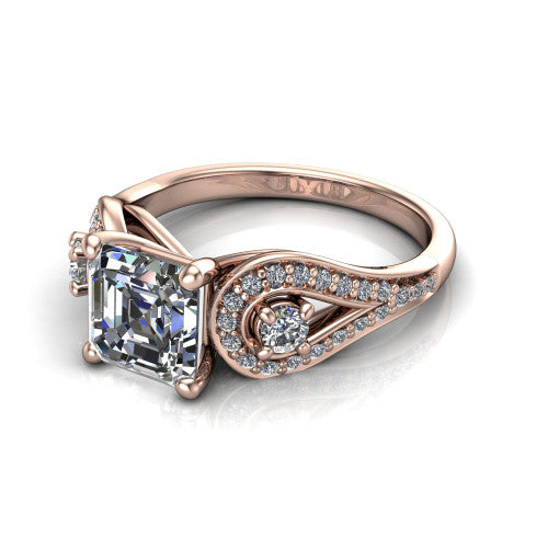 Jennifer square emerald three stone engagement ring in 18K Rose Gold, three-quarter perspective showing the step-cut square emerald center diamond flanked by two round side diamonds in pave teardrop frames on a pave split shank