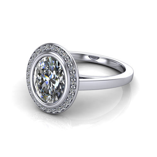 Rosie oval halo bezel-set engagement ring in 18K White Gold — three-quarter perspective showing the oval-cut center diamond, pavé diamond halo, and slim high-polish shank