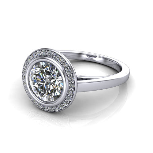 Rosie round halo bezel-set engagement ring in Platinum — three-quarter perspective showing the brilliant round center diamond, pavé diamond halo, and slim high-polish shank