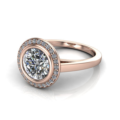 Rosie round halo bezel-set engagement ring in 18K Rose Gold — three-quarter perspective showing the brilliant round center diamond, pavé diamond halo, and slim high-polish shank