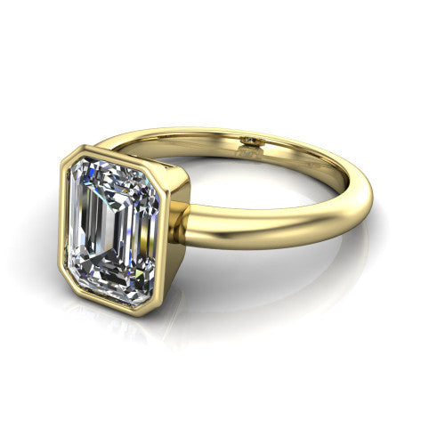 Lauren emerald bezel solitaire engagement ring in 18K Yellow Gold, three-quarter perspective showing the bezel-set emerald center diamond on a polished band