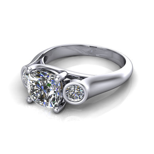Rory cushion three stone engagement ring in Platinum, three-quarter perspective showing the cushion center diamond between two bezel-set round side stones