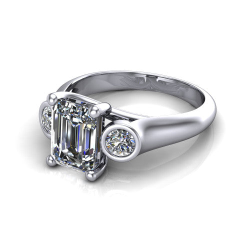Rory emerald three stone engagement ring in 14K White Gold, three-quarter perspective showing the emerald center diamond between two bezel-set round side stones