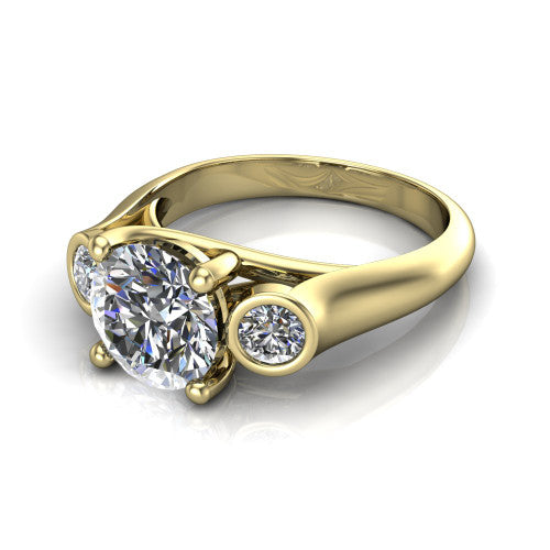 Rory round three stone engagement ring in 18K Yellow Gold, three-quarter perspective showing the round center diamond between two bezel-set round side stones