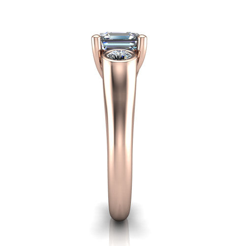 Rory square emerald three stone engagement ring in 14K Rose Gold, side profile showing the bezel side stones and polished band