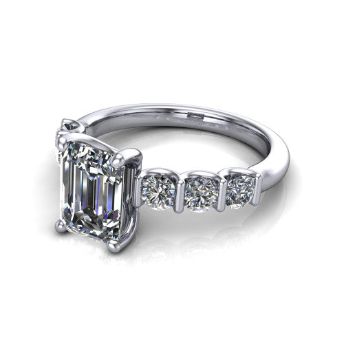 Liora emerald solitaire engagement ring in Platinum, three-quarter perspective showing the emerald center diamond with graduated round side accents on a polished band