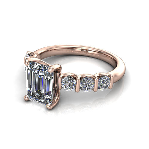 Liora emerald solitaire engagement ring in 18K Rose Gold, three-quarter perspective showing the emerald center diamond with graduated round side accents on a polished band