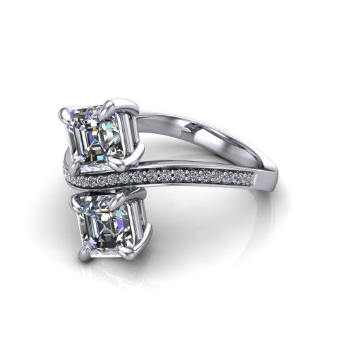 Elowen square emerald two stone engagement ring in Platinum, three-quarter perspective showing two square emerald diamonds on a pave bypass band