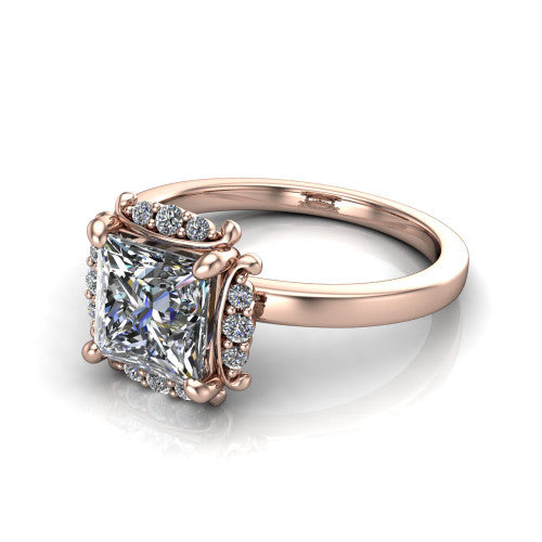 Mckenna princess-cut halo engagement ring in 18K Rose Gold, three-quarter perspective showing the princess-cut center diamond, diamond halo, and polished band