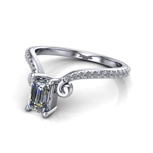 Aveline emerald solitaire engagement ring in Platinum, three-quarter perspective showing the emerald center diamond above a chevron pave band with scroll shoulders