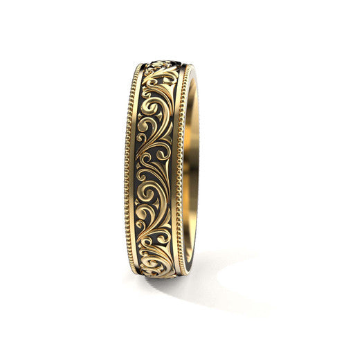 Handcrafted men's yellow gold wedding band featuring detailed scrollwork designs and engraved borders