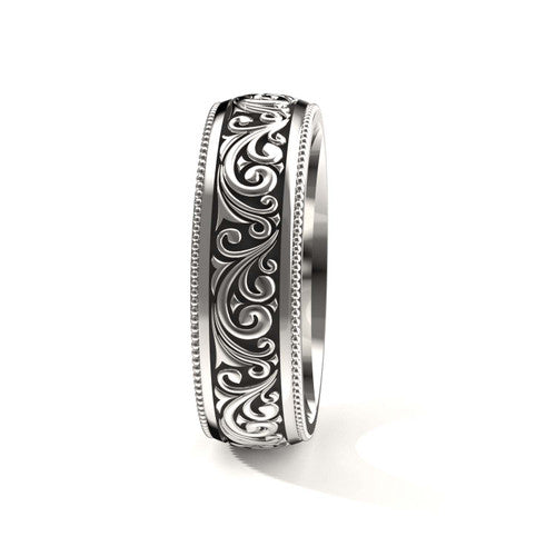 Handcrafted men's white gold wedding band featuring detailed scrollwork designs and engraved borders
