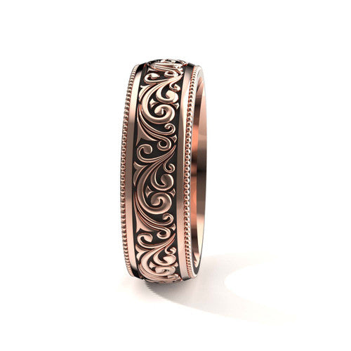 Elegant 14K rose gold men's wedding band featuring intricate scrollwork and engraved edges