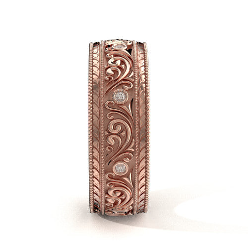 Handcrafted men's rose gold wedding band featuring detailed scrollwork, engraved edges, and diamond accents