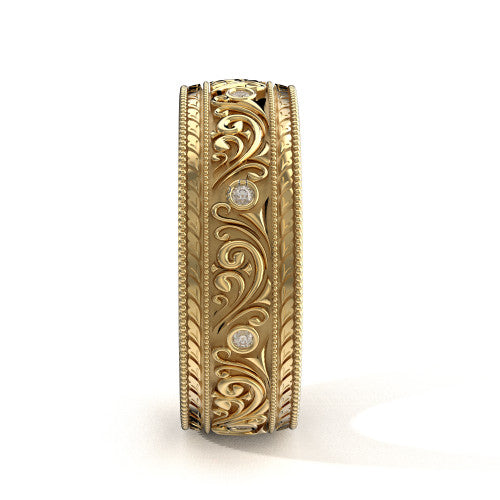 Handcrafted men's yellow gold wedding band featuring detailed scrollwork, engraved edges, and diamond accents