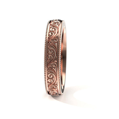 Vintage-style 14K rose gold men's wedding band featuring intricate scrollwork and engraved edges