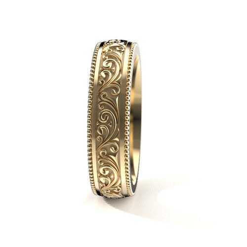 Classic men's yellow gold wedding ring with intricate scroll design and engraved borders