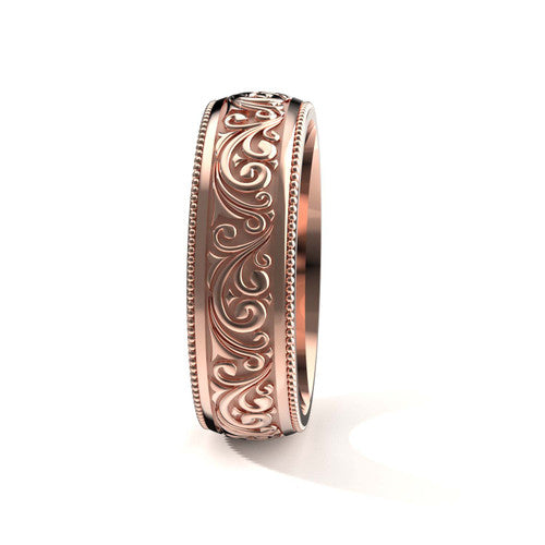 Handcrafted men's rose gold wedding band featuring detailed scrollwork designs and engraved borders