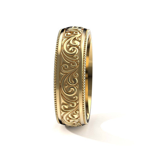 Handcrafted men's yellow gold wedding band featuring detailed scrollwork designs and engraved borders